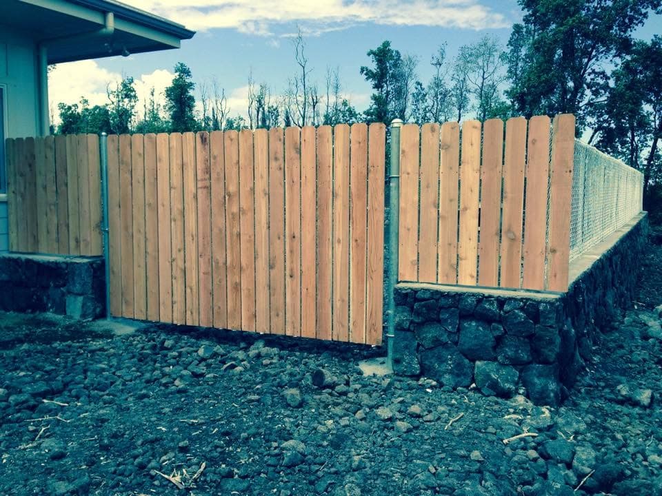 Wood dog-ear picket fence line — On The Line Fencing project, Big Island, Hawaii
